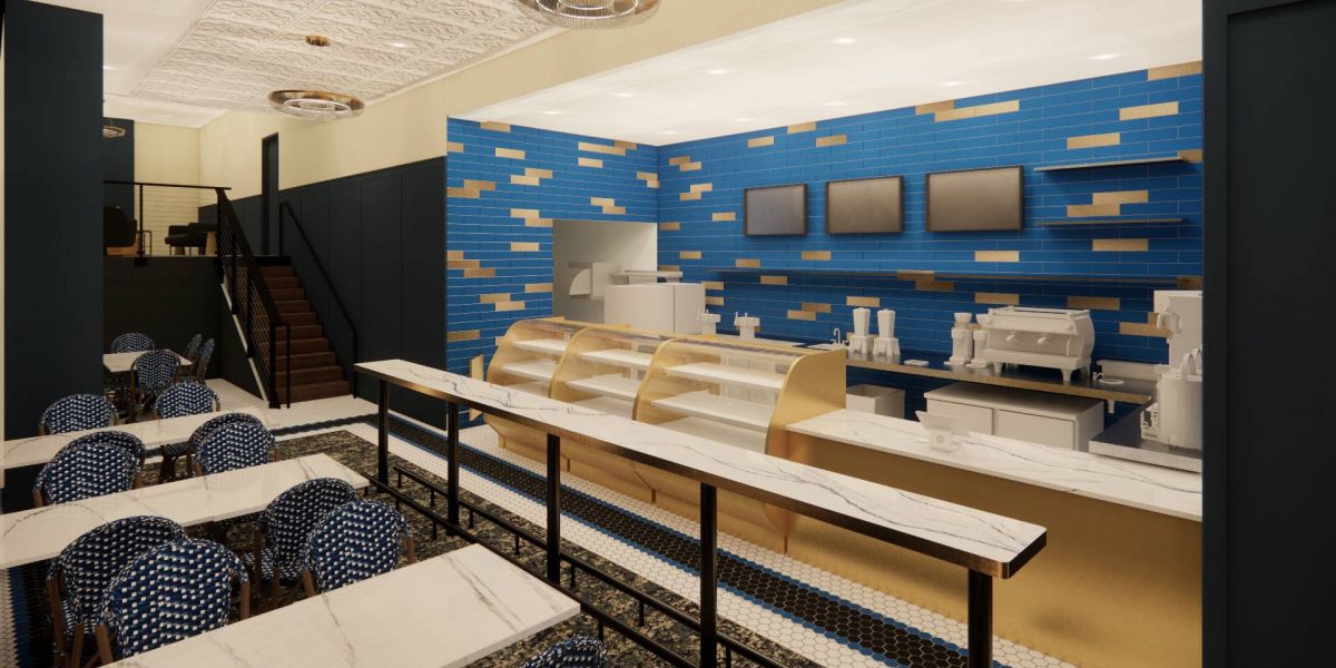 The modern café at Mother Dough Bakery in The Vicinity, showcasing a sleek counter with blue and gold tile backsplash, and stylish seating with patterned chairs.